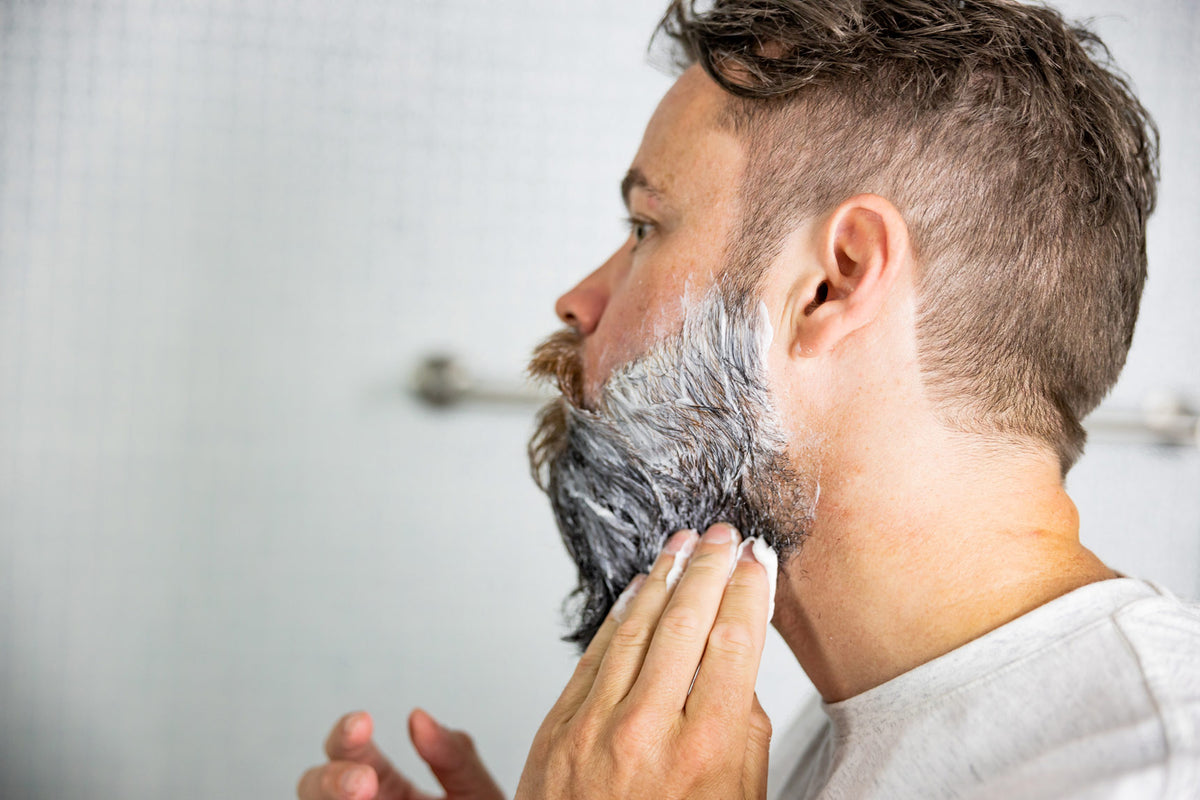 Man applying beard mask